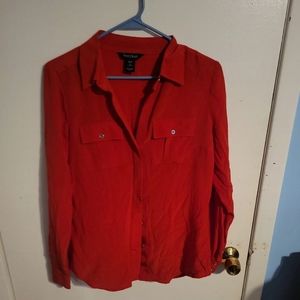 Woman's top by white house